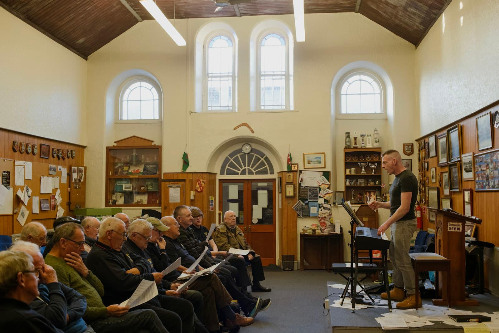 A community choir rehearsing in a village hall, representing the grassroots, community-led organisations Comic Relief funds